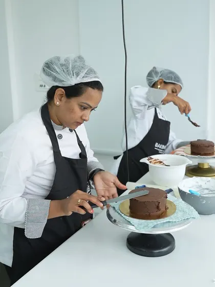 Our students work side-by-side, here focusing on frosting their chocolate cakes. The classroom environment is collaborative and supportive, allowing everyone to learn together and from each other.