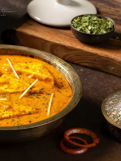 A side angle of the Paneer-e-Rubaruh, showing the dish with traditional serveware.