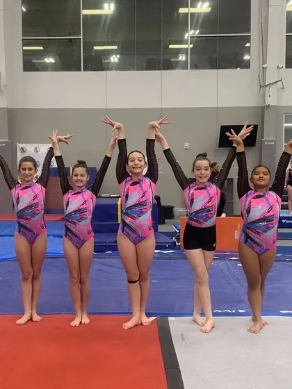 The Xcel Silver team stands united on the competition floor. We are so proud of how they represented our gym.