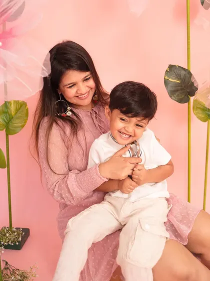 Pure joy and laughter between a mother and her son. This candid moment was captured during my pink floral-themed Mother's Day mini-sessions.