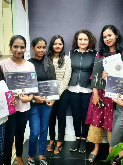 A group of graduates from our various beauty programs, including nail artistry, holding their certificates. We offer a comprehensive education for a complete career in cosmetology.