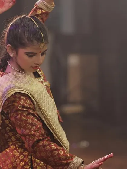 A young performer in a moment of concentration during her group dance at Varshik Utsav 2024.