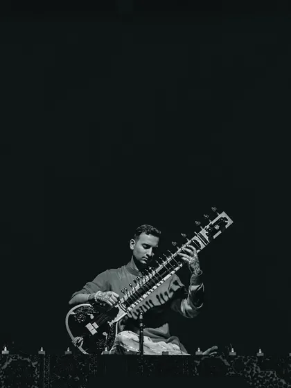 A focused, black and white shot from the India Tour 2024. The intensity of the music is matched by the intensity of the performance.
