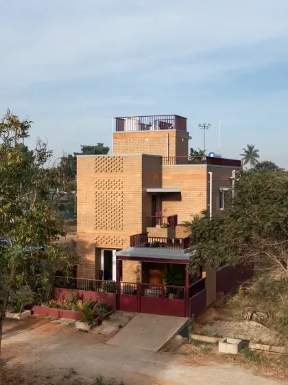 An elevated view of the Eesha residence, showing how the structure is nestled among the trees, with a rooftop terrace for enjoying the surrounding views.