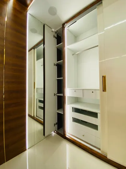 Here you can see the internal layout of the wardrobe, with a mix of shelves, drawers, and hanging space. We also included a slim, pull-out shelf for accessories.