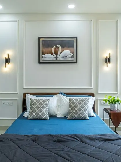 In 'Bohemian Bliss', the master bedroom follows a Brit-chic theme with a cerulean and alabaster palette. The sliding wardrobe has a modern, graphic design, and wall moldings add a classic touch.
