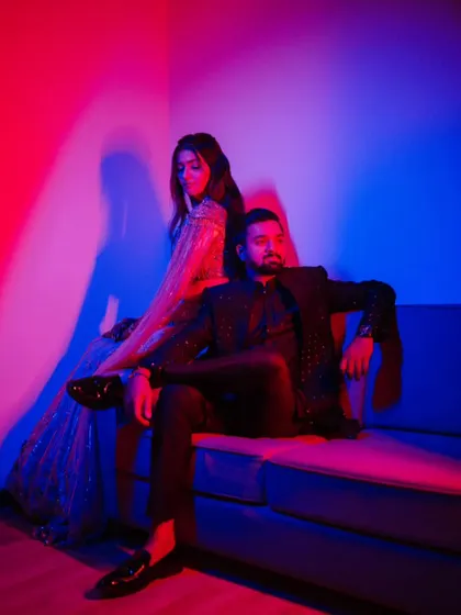 A bold and modern portrait using red and blue gels for a dramatic lighting effect. This is for couples who want something artistic and different from traditional engagement photos.