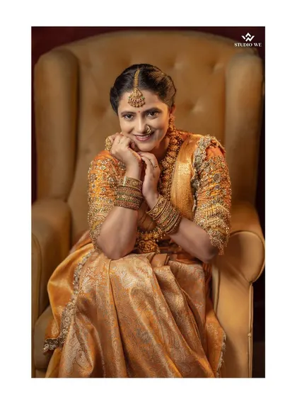 A playful and happy portrait of the bride in a classic yellow armchair.