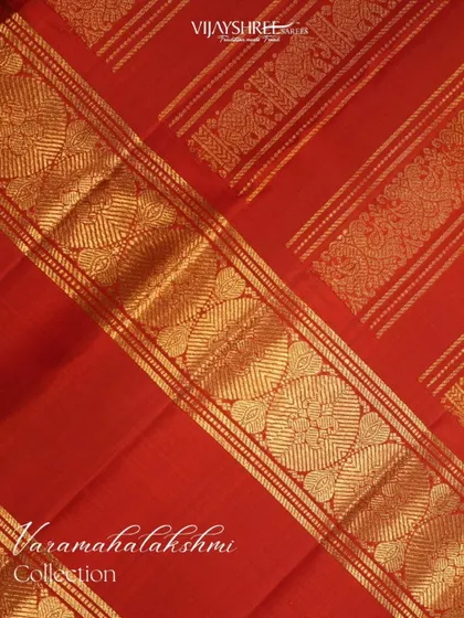 A close-up of the intricately woven gold zari border.