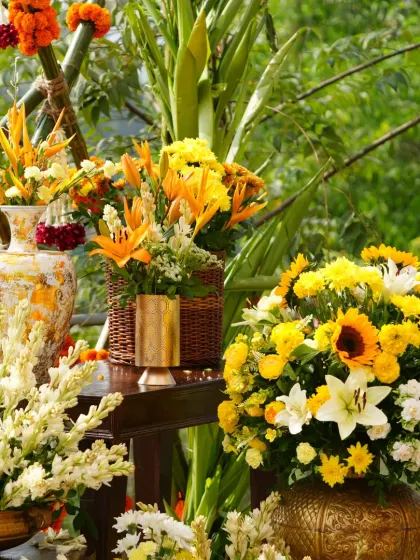 Another angle of the lush floral arrangements, with the bamboo lattice backdrop creating a perfect rustic setting.
