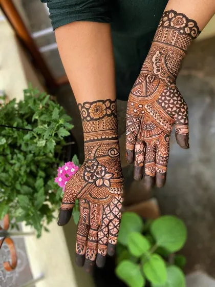 A lovely semi-filled design that combines floral work with geometric patterns. This style is great for someone who wants an intricate look that isn't as dense as a full bridal design.