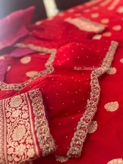 The front of the red blouse, with a simple embroidered border.