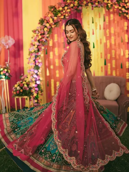 The bride's dupatta flows beautifully as she twirls, creating a graceful and dynamic Sangeet portrait.
