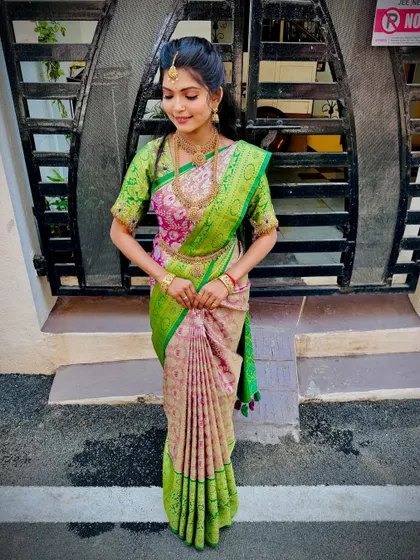 The full view of the saree with fluffy pleats. The drape is both traditional and eye-catching.