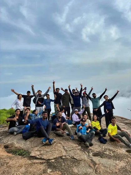 An energetic group celebrating their achievement on a misty mountain top. We plan treks that are not just about hiking but about creating lasting, positive memories.