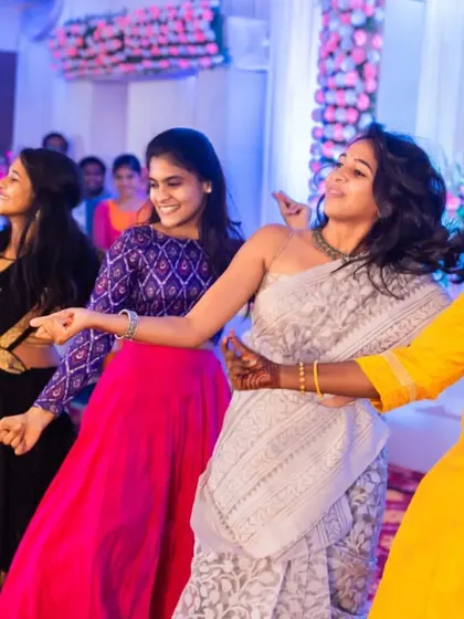 Friends dancing together in a last-minute, joy-filled performance. We are experts at on-the-spot choreography to ensure no one misses out on the fun.