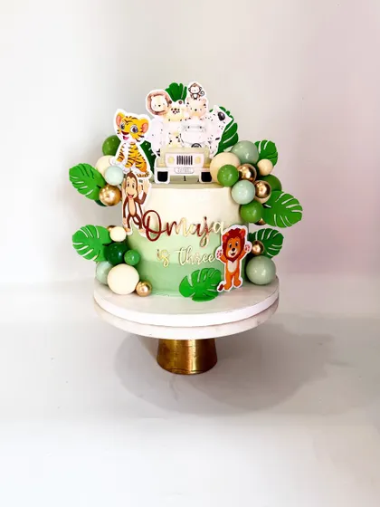 Another angle of the modern jungle theme cake. The ombre green effect on the ganache adds depth and style to the design.