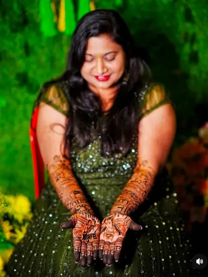 A beautiful bride displaying her palms, which feature a unique design with personalized symbols.