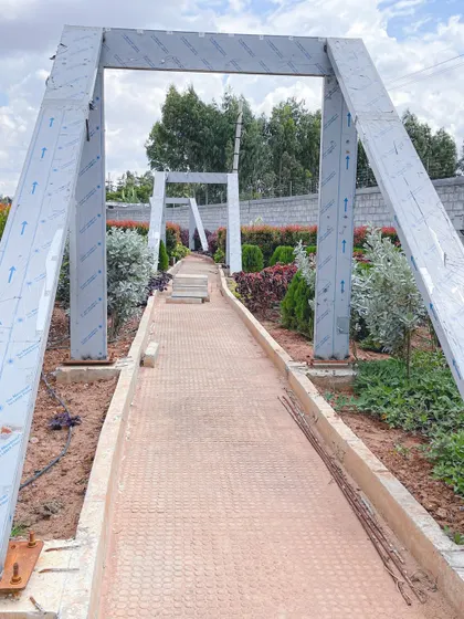 The structural framework for a series of modern archways being installed at 'The Sanctuary', showing the underlying engineering of our landscape features.