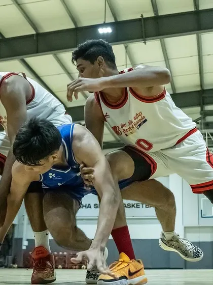 The battle for possession. Three players dive for a loose ball, showing the hustle we expect in every game.