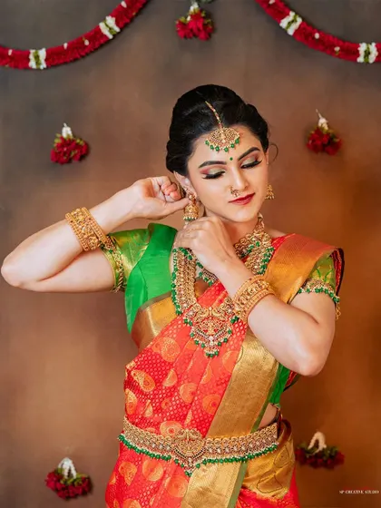 A classic pose from a bridal lookbook shoot, showing the model adjusting her earring.