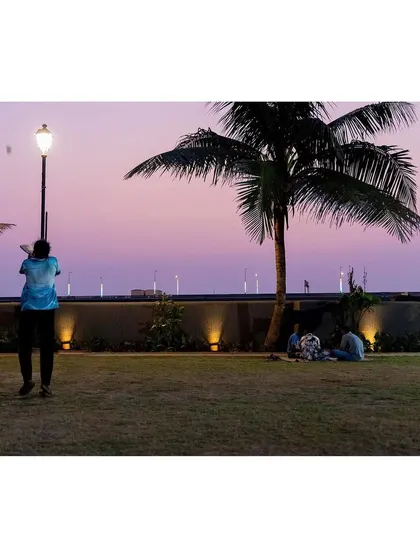 As dusk settles over the Worli Fishing Village, the Gora Dabkal ground transforms. The landscape lighting design provides safety and ambiance, ensuring the park remains a cherished community hub for relaxation and connection well into the evening, with the sea-link as a backdrop.