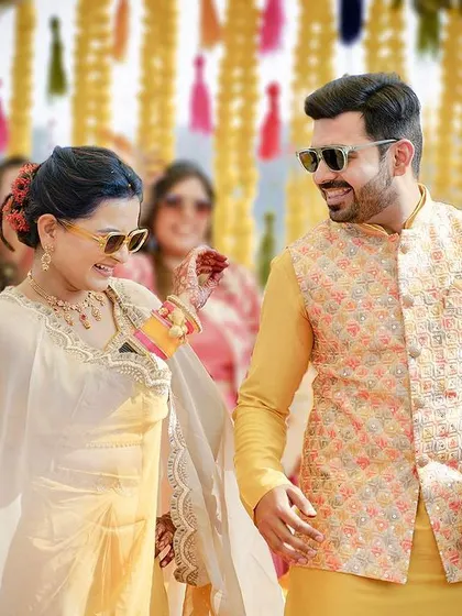 Another playful moment from the haldi, where the couple's fun-loving personalities shine. These candid interactions are what make wedding memories so special.