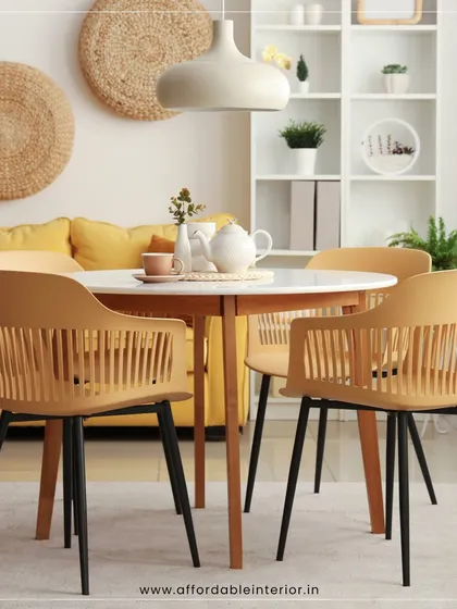 A bright and cheerful dining setup featuring a round table and modern chairs in a sunny yellow hue, demonstrating our ability to create vibrant and happy spaces.