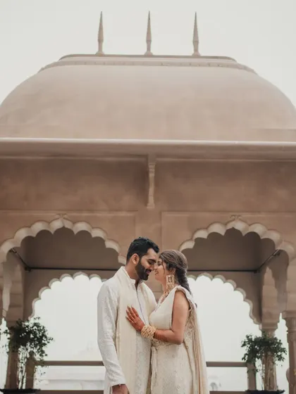 The couple framed by the beautiful arches of the Fairmont Jaipur. We use the venue's best features to create stunning photographic moments.