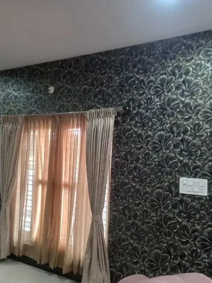 A dark, textured wallpaper with a large leaf pattern. This dramatic design is perfect for creating a moody and luxurious accent wall in a bedroom.