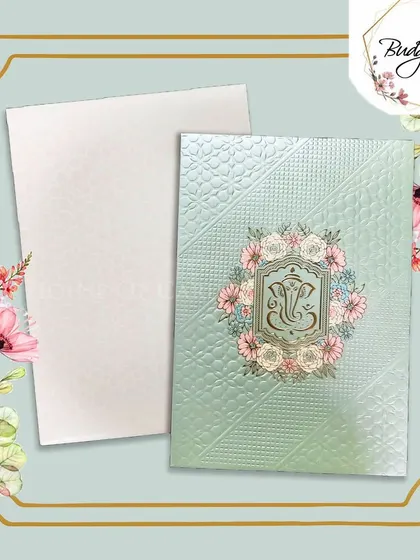 A pastel green invitation with a floral Ganesha design, offering a modern take on a traditional religious motif.