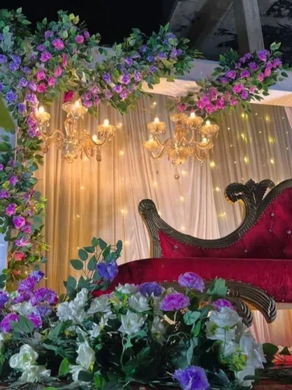 A close-up of the lush floral arrangements and chandelier lighting from the anniversary setup.