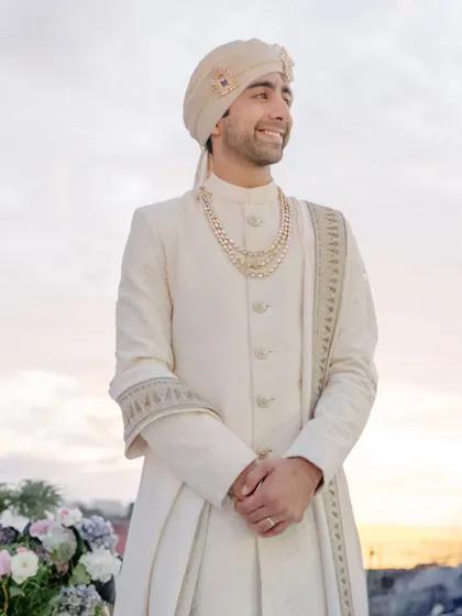 The groom waits, his face filled with emotion, as the sun sets over Turkey. We do it all for this moment, when time slows and he sees his bride walking toward forever.