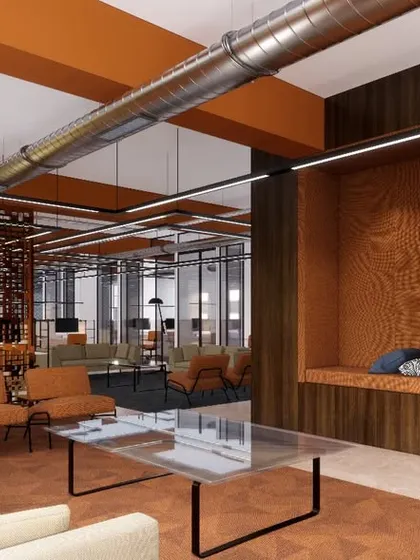 A lounge area within the co-working space, featuring comfortable seating and cozy, wood-lined nooks for quiet work or private conversations.