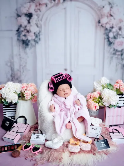 The full spa day setup, complete with miniature shopping bags and flowers. This theme is perfect for a glamorous and fun baby girl session.