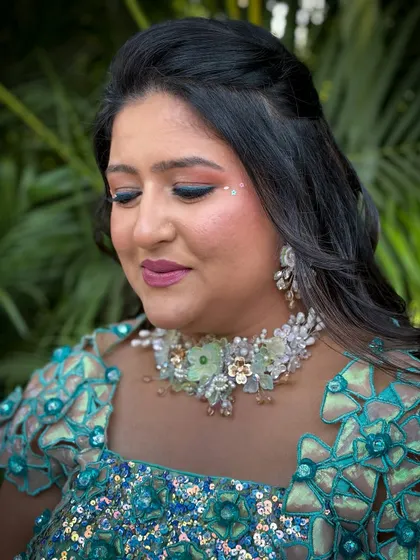 A close-up of the carnival makeup, with eyes closed to show the blend of eyeshadow and the delicate gem accents.