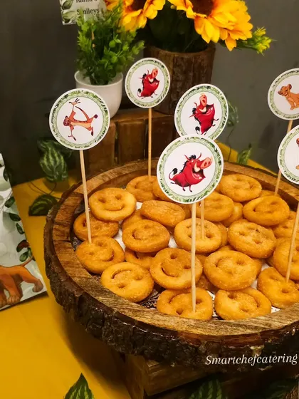 Even simple snacks get a themed twist. Here, smiley fries are decorated with Lion King character toppers, making them an instant hit with the kids at this jungle party.
