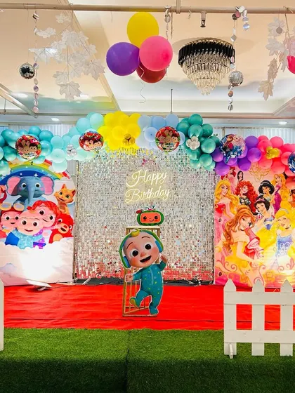 A creative twins' birthday party combining Cocomelon and Disney Princess themes on one stage.