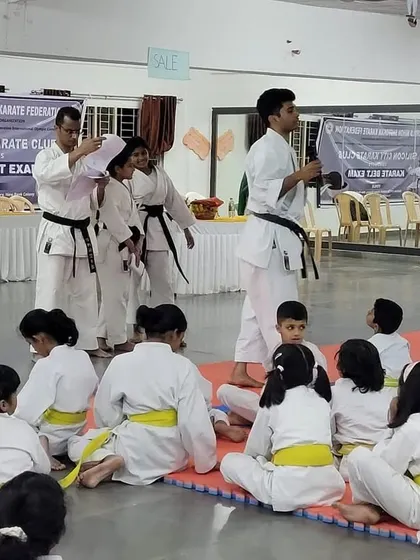 Senior instructors carefully observe and guide students during the belt exam, ensuring every technique is performed with precision and understanding.