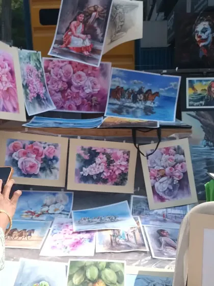 A display of my various watercolor paintings at the Chithra Santhe. You can see a range of subjects, from floral art to landscapes, which are all part of the foundational skills we build for portraiture.