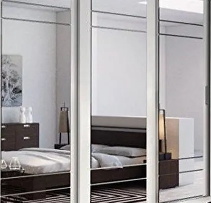 A floor-to-ceiling mirrored wardrobe that not only provides ample storage but also makes the room feel larger and brighter.