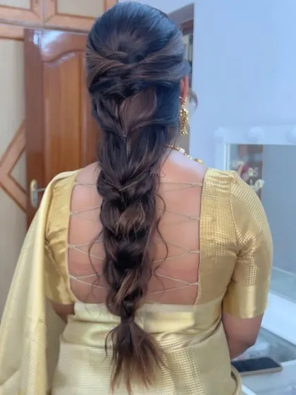 A messy, textured braid that is perfect for a relaxed yet chic bridal look, especially for pre-wedding events.