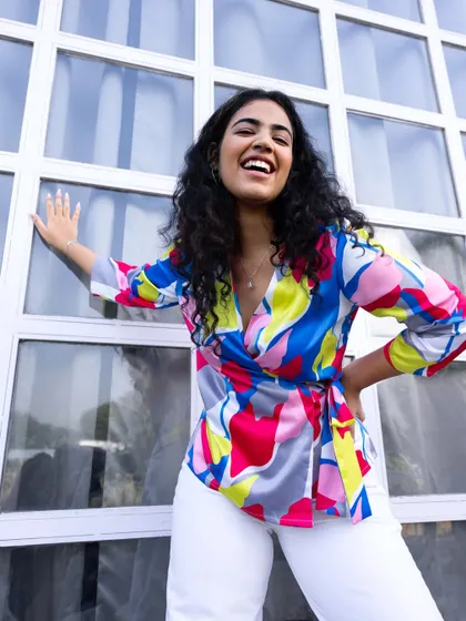 Color can completely change your mood, and I’m a huge believer in dopamine dressing. This is from a professional campaign I styled and modeled for, showing how to pair a vibrant, multi-colored top with simple white pants for a look that’s joyful and sophisticated.