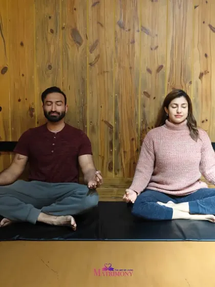 Another couple meditating, this time in a rustic, cozy setting. It shows that the practice of meditating together can be a part of any lifestyle, strengthening the bond.