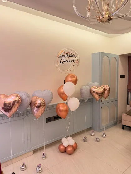 We love creating the perfect birthday aesthetic. This assorted balloon bouquet features rose gold hearts, a personalized "Happy Birthday Queen" bubble balloon, and a soft pastel color palette for a totally chic celebration.
