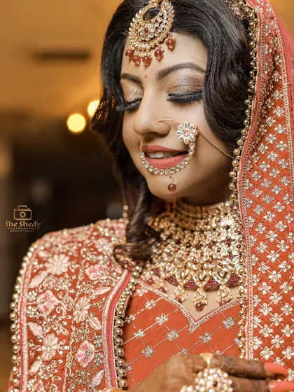 A close-up shot capturing the bride's shy smile and beautiful makeup. These soft, intimate portraits are a favourite among our brides.