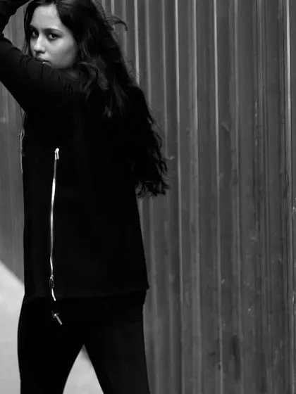 A dynamic pose that conveys confidence and attitude. The black and white treatment enhances the urban, edgy vibe of the shoot.