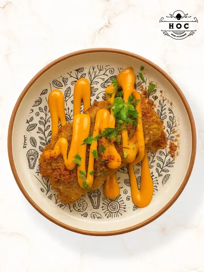 This dish features soft, pan-fried cottage cheese seasoned with a crunchy, aromatic dukkah spice blend from the Middle East. It is served with a creamy sauce and fresh herbs for a complex and satisfying flavor.
