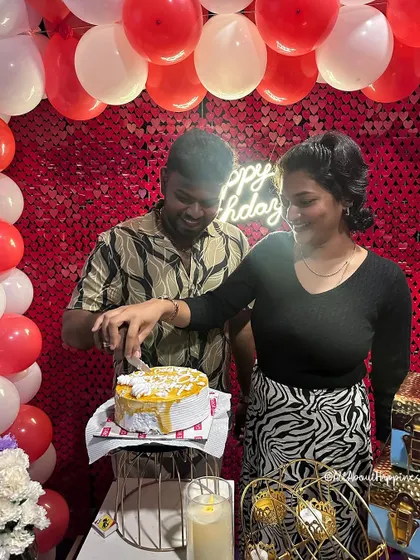 A couple cutting their cake in front of a shimmering red sequin backdrop during their private theatre surprise. It's a celebration fit for the big screen.