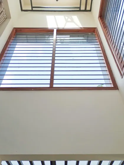 The story of lines. This double-height Pooja space is filled with natural light from the large grilled windows, creating a dramatic play of shadows. I believe a sacred space should never be confined in a box; it should feel open and connected to the heavens.